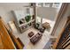 Elegant living room with a stone fireplace, leather furniture, and tall windows, creating a bright and inviting space at 14315 Hampshire Bay Cir, Winter Garden, FL 34787