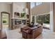 Cozy living room with stone fireplace and view of the outdoor pool area at 14315 Hampshire Bay Cir, Winter Garden, FL 34787