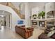 Open-concept living area with stone fireplace and staircase at 14315 Hampshire Bay Cir, Winter Garden, FL 34787
