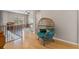 Upstairs loft with a stylish wicker egg chair and views of the playroom, offering a cozy and unique relaxation space at 14315 Hampshire Bay Cir, Winter Garden, FL 34787