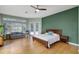 Large main bedroom with wood floors, sitting area, and view of pool at 14315 Hampshire Bay Cir, Winter Garden, FL 34787