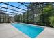 Private screened-in pool with an outdoor lounging area and lush landscaping at 14315 Hampshire Bay Cir, Winter Garden, FL 34787