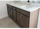 Bathroom vanity with double sinks, quartz countertop, and shaker-style cabinets at 14647 Crestavista Dr, Clermont, FL 34714