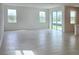 Spacious room with tile floors, large windows, and sliding doors offering natural light and outdoor access at 14647 Crestavista Dr, Clermont, FL 34714