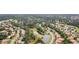Aerial view of the neighborhood showcasing the home's proximity to lakes, lush landscaping, and other homes at 1518 Shadowmoss Cir, Lake Mary, FL 32746