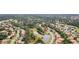 Aerial view of the neighborhood showcasing the home's proximity to lakes, lush landscaping, and other homes at 1518 Shadowmoss Cir, Lake Mary, FL 32746