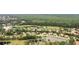 Overhead view of the neighborhood showing lush landscaping and a pond nearby at 1518 Shadowmoss Cir, Lake Mary, FL 32746