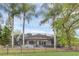 Backyard featuring a fenced-in pool, plenty of outdoor furniture, a manicured lawn and landscaping at 1518 Shadowmoss Cir, Lake Mary, FL 32746