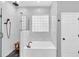 Modern bathroom with a standalone tub, walk-in shower, and stylish black fixtures, offering a spa-like experience at 1518 Shadowmoss Cir, Lake Mary, FL 32746