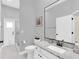 Bright bathroom with granite countertop, walk-in shower, and modern fixtures providing a clean and luxurious feel at 1518 Shadowmoss Cir, Lake Mary, FL 32746