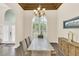 Dining room featuring a rustic wood table, large window, and elegant chandelier at 1518 Shadowmoss Cir, Lake Mary, FL 32746