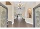 Grand foyer featuring tile flooring, a decorative niche, and an elegant chandelier at 1518 Shadowmoss Cir, Lake Mary, FL 32746