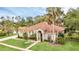 Beautiful single-story home with tile roof, well-manicured lawn, and mature tropical landscaping at 1518 Shadowmoss Cir, Lake Mary, FL 32746