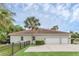 Three car garage with an elegant driveway surrounded by manicured landscaping and a palm tree at 1518 Shadowmoss Cir, Lake Mary, FL 32746