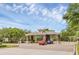 A gated community entrance with stone pillars and a tiled roof, surrounded by mature trees and landscaping at 1518 Shadowmoss Cir, Lake Mary, FL 32746