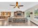 Spacious living room with an entertainment center, modern furniture and a view of the gourmet kitchen at 1518 Shadowmoss Cir, Lake Mary, FL 32746