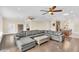 Comfortable living room with a large sectional sofa, hardwood floors, and stylish decor, great for relaxation at 1518 Shadowmoss Cir, Lake Mary, FL 32746