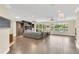 Spacious living room featuring tile floors, a built-in entertainment center, and backyard pool views at 1518 Shadowmoss Cir, Lake Mary, FL 32746