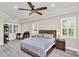 Serene main bedroom featuring a tray ceiling, neutral color palette, and ample natural light from the large windows at 1518 Shadowmoss Cir, Lake Mary, FL 32746
