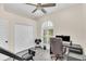Well-lit office space featuring a large window, ample storage, and exercise equipment for a productive and healthy lifestyle at 1518 Shadowmoss Cir, Lake Mary, FL 32746