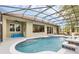 Screened in pool with water feature, ample patio seating, and tile accents at 1518 Shadowmoss Cir, Lake Mary, FL 32746