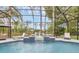 Luxurious screened-in pool with a fountain and comfortable seating, perfect for relaxation and entertaining guests at 1518 Shadowmoss Cir, Lake Mary, FL 32746