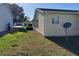 View of the side yard, featuring well-maintained lawn and vinyl siding at 1705 Betrillo Ct, The Villages, FL 32162