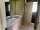Neutral bathroom with a large mirror and a peach toned vanity at 1705 Betrillo Ct, The Villages, FL 32162