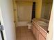 Full bath featuring a tub with shower, and a large vanity at 1705 Betrillo Ct, The Villages, FL 32162