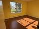 Bedroom featuring a window view, and a wood-look floor at 1705 Betrillo Ct, The Villages, FL 32162