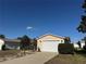 Charming one-story home with a well-maintained lawn and attached two-car garage at 1705 Betrillo Ct, The Villages, FL 32162