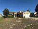 Lovely one-story home with lush landscaping, mature trees, and a convenient attached garage at 1705 Betrillo Ct, The Villages, FL 32162