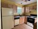 Well-lit kitchen featuring standard appliances and ample cabinet space for storage at 1705 Betrillo Ct, The Villages, FL 32162