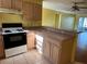 Functional kitchen featuring standard appliances and a convenient breakfast bar at 1705 Betrillo Ct, The Villages, FL 32162