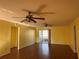 Spacious living room featuring hardwood floors, ceiling fans, and access to the lanai at 1705 Betrillo Ct, The Villages, FL 32162