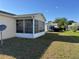 A backyard with a sunroom, offering bright natural light at 1705 Betrillo Ct, The Villages, FL 32162