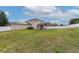 Expansive backyard featuring lush green grass, a white fence, and a charming pergola at 1710 Alejo Dr, Apopka, FL 32712