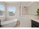 Bathroom with soaking tub, tile floor, and large windows at 1710 Alejo Dr, Apopka, FL 32712