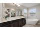 Bathroom features a large vanity, soaking tub, and separate shower at 1710 Alejo Dr, Apopka, FL 32712