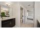 Well-lit bathroom with neutral tiling, an open doorway to the bedroom, and a connecting toilet room at 1710 Alejo Dr, Apopka, FL 32712