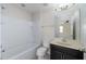 Bright bathroom featuring a shower-tub combination and a vanity with a dark cabinet at 1710 Alejo Dr, Apopka, FL 32712