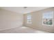 Neutral bedroom with carpet, two bright windows, and baseboard molding at 1710 Alejo Dr, Apopka, FL 32712