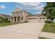 Spacious driveway leading to a three-car garage with a well-maintained lawn at 1710 Alejo Dr, Apopka, FL 32712