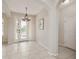 Inviting foyer with tile flooring, decorative light fixture, and a 