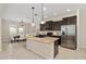 Well-lit kitchen features granite counters, stainless appliances, and dark cabinets at 1710 Alejo Dr, Apopka, FL 32712