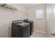 Laundry room with front-loading washer and dryer, plus overhead shelving at 1710 Alejo Dr, Apopka, FL 32712