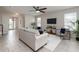 Cozy living room featuring neutral tones, tile floors, and modern furniture at 1710 Alejo Dr, Apopka, FL 32712