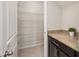 Pantry with built-in wire racks and granite counters at 1710 Alejo Dr, Apopka, FL 32712