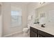 Well-lit powder room with a modern vanity, decorative mirror, and a window at 1710 Alejo Dr, Apopka, FL 32712