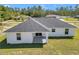 Aerial view of home with white walls, dark roof, and green grass at 17468 Sw 36Th Ter, Ocala, FL 34473
